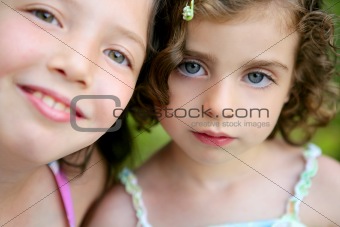 closeup portrait of two little girl sisters