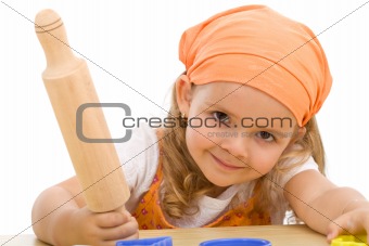 Happy girl with a rolling pin