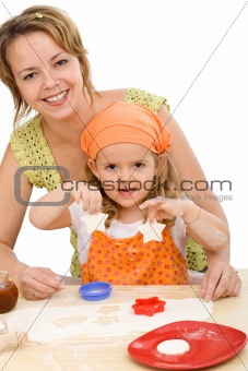 Woman and little girl making cookies