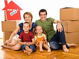 Happy family with cardboard boxes moving in a new home