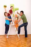 Happy family with painting utensils repainting their home
