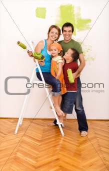 Happy family painting their new home together
