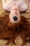 Redhead woman with black stones treatment