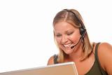 Attractive businesswoman smiles as she talks on her phone headset.