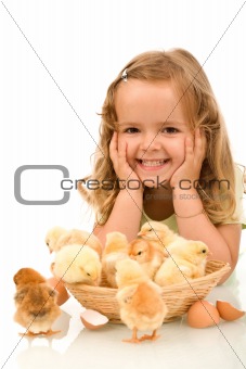Happy girl with her little chickens
