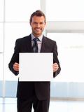Handsome smiling businessman showing a white card