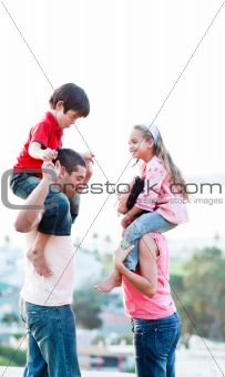 Parents giving their children piggyback rides