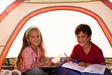Kids drawing in a tent