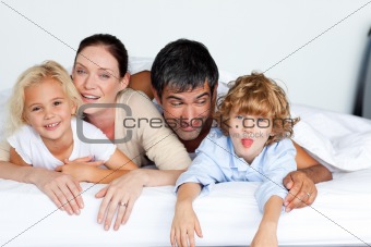 Happy family together on bed