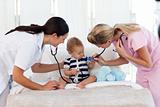 Nurse and pediatrician attending to a baby