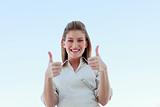 Businesswoman smiling at the camera with thumbs up