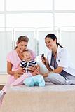 Baby with pediatrician and nurse with copy-space
