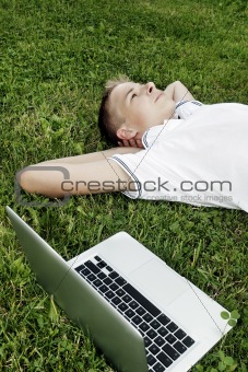 Boy lying on grass 