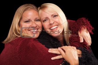 Two Beautiful Smiling Sisters Portrait Isolated on a Black Background.