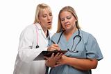 Two Doctors or Nurses Looking over File on Clipboard Isolated on a White Background.