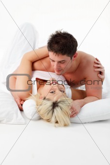 Smiling girl with her boy resting in bed