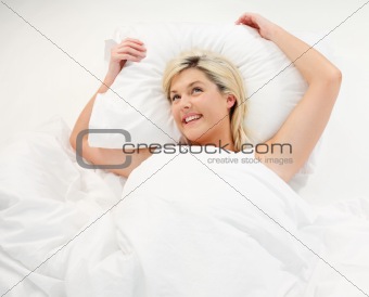 Happy girl lying in bed
