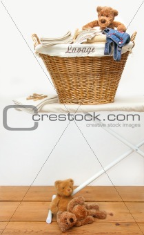 Laundry basket with teddy bears on floor