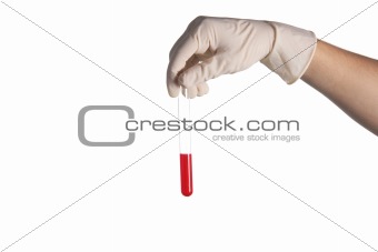 hand in a rubber glove holds a test tube with a liquid