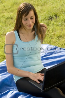 Woman with laptop working outdoor