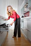young beautiful woman standing in modern kitchen interior