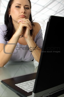 Serious woman behind a laptop