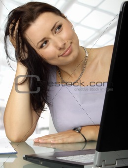 Satisfied woman behind a laptop