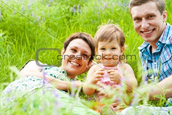 Family having rest in the meadow