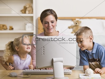 Woman and Children Playing on Computer