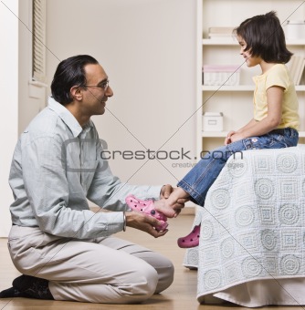 Father Helping Daughter with Shoes