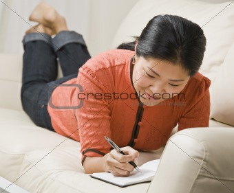 Woman Writing in Book