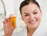 Woman Holding up Medication