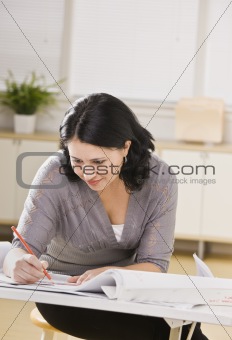 Woman Working on Blueprints