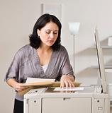Attractive asian woman making copy.