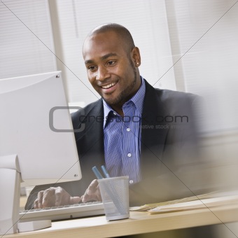 Attractive African American at computer.