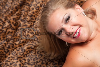 Beautiful Blonde Model Poses on Leopard Blanket.