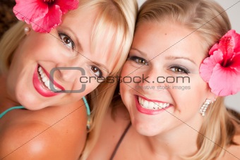 Beautiful Smiling Girls with Hibiscus Flowers in Their Hair.