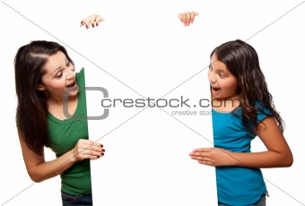 Pretty Hispanic Girl and Mother Holding Blank Board Isolated on a White Background.