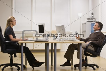 Man and Woman Chatting in Office