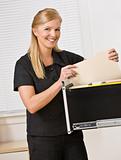 Woman Looking Through Filing Cabinet