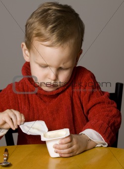 Boy opening yogurt