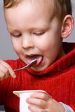 Boy eating yogurt