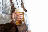 Bavarian man hold beer stein at Oktoberfest