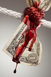 Wrinkled American Dollar Tied Up and Bleeding in Rope.