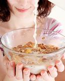 Young people eating milk with cereals