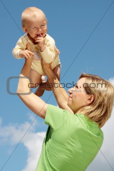 Mother with baby under blue sky