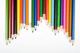 Assortment of coloured pencils with shadow on white background