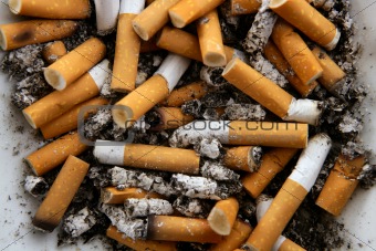Ashtray full of cigarettes. Dirty tobacco texture