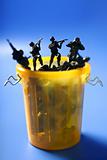 Toy soldiers row on the trash, end of war metaphor