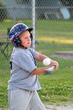 Boy batting baseball